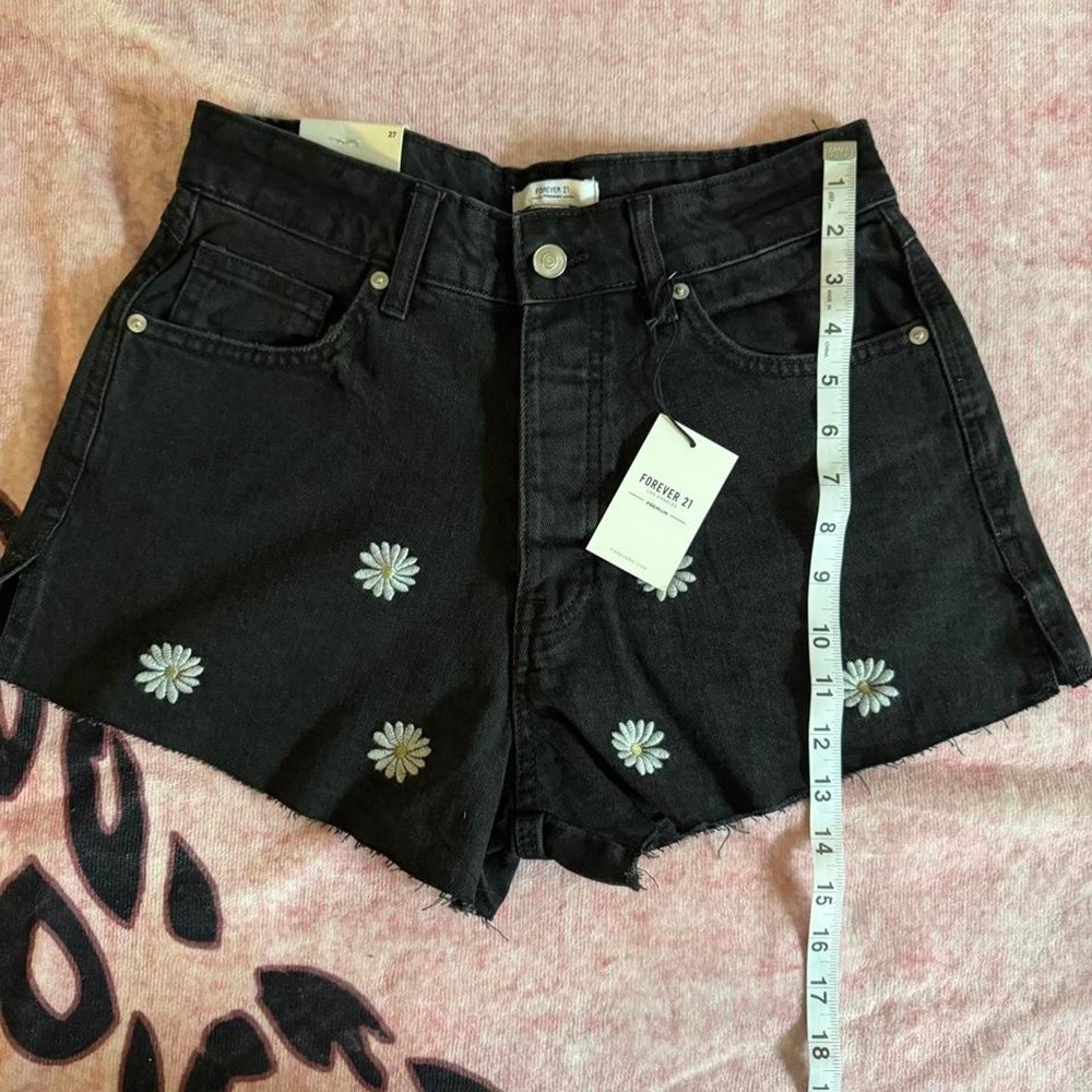 Forever 21 black denim shorts with white daisy embroidery,